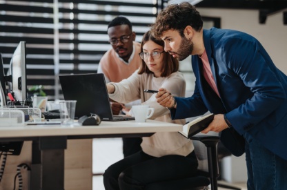 group of people looking at a computer