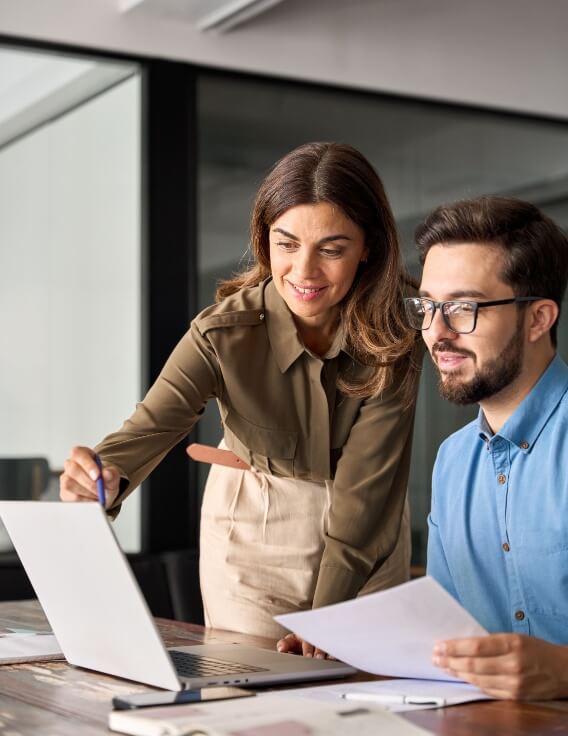 two professionals looking at a computer
